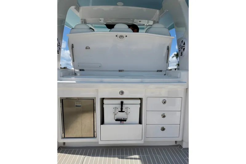 Slide: The Image of 2023 Intrepid 427 Nomad FE boat interior with storage compartments and seating. - 31