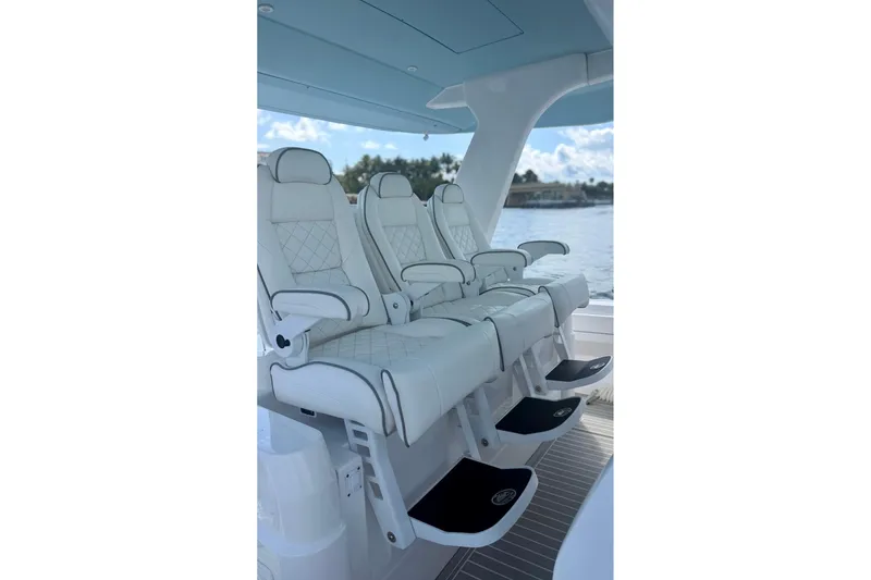 Slide: The Image of Luxurious seating on 2023 Intrepid 427 Nomad FE boat, featuring elegant white upholstery. - 13