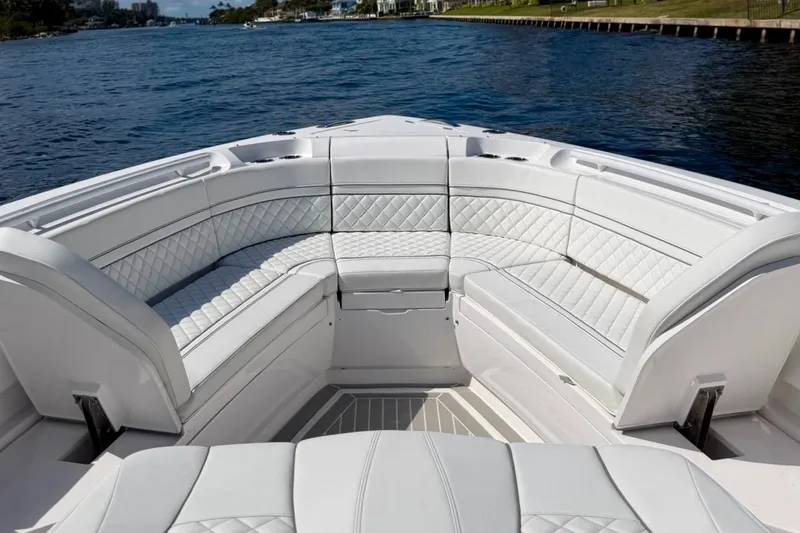Slide: The Image of Luxurious seating on the 2023 Intrepid 427 Nomad FE boat, cruising on a serene waterway. - 15