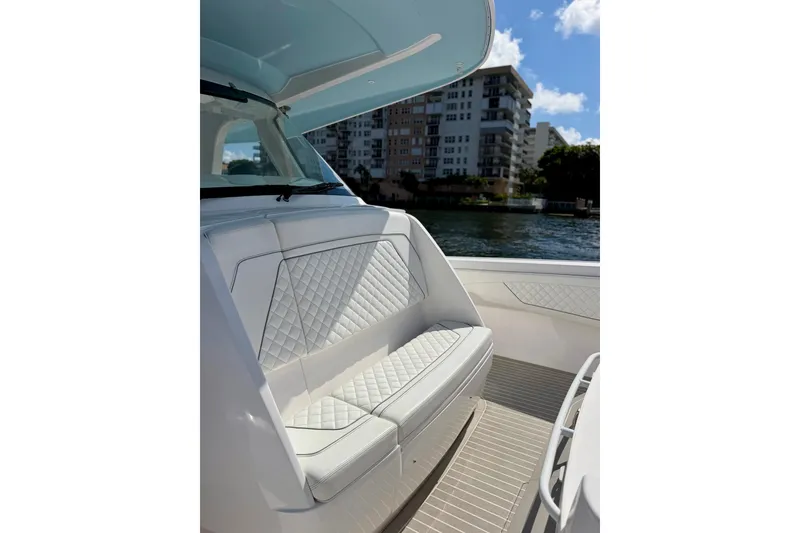 Slide: The Image of Luxurious seating on the 2023 Intrepid 427 Nomad FE boat, with waterfront view. - 24