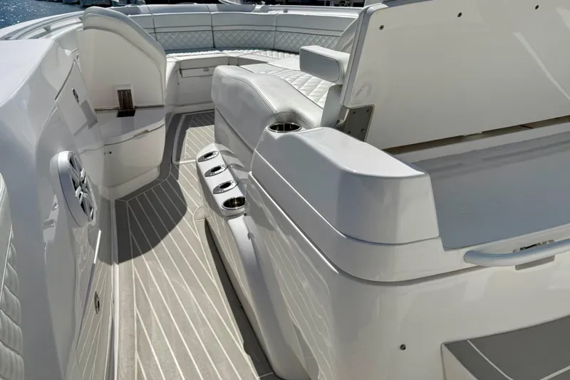 Slide: The Image of 2023 Intrepid 427 Nomad FE boat interior with sleek white seating and modern design. - 17