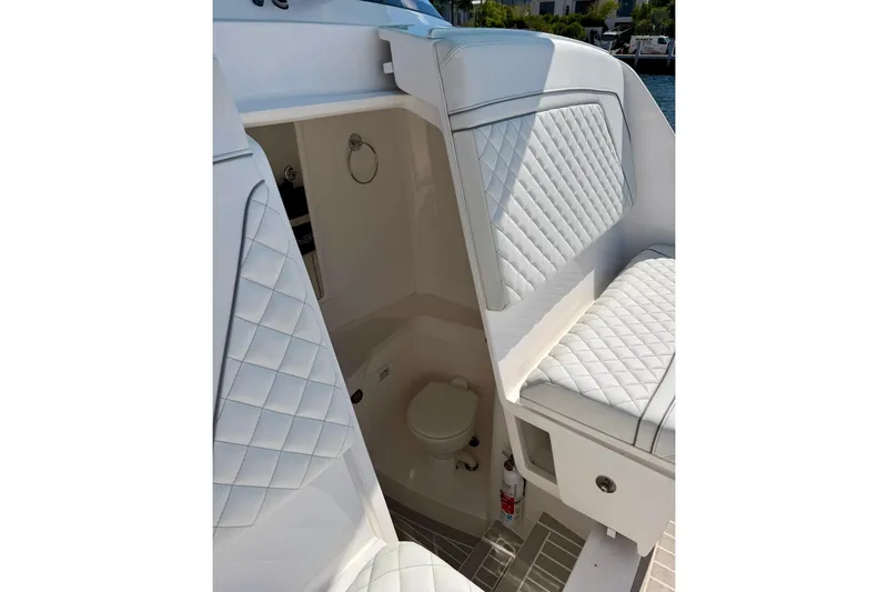 Slide: The Image of Luxurious interior of 2023 Intrepid 427 Nomad FE boat with quilted seating and compact restroom. - 25