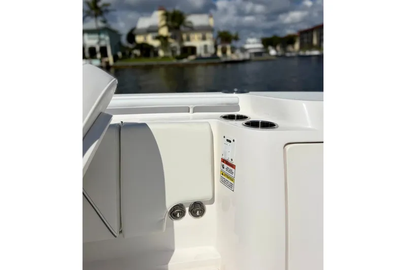 Slide: The Image of 2023 Intrepid 427 Nomad FE boat interior with cup holders and waterfront view. - 20