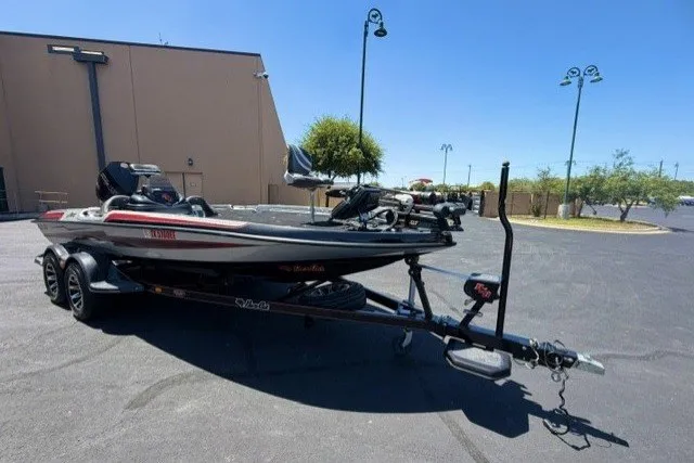 The Image of 2018 Bass Cat Caracal boat on trailer in parking lot, sunny day. - 1