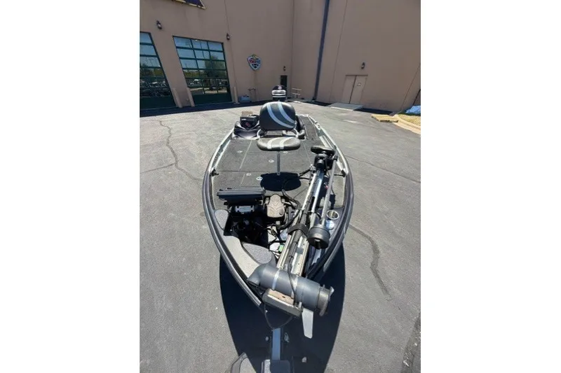 Slide: The Image of 2018 Bass Cat Caracal boat parked outdoors, showcasing deck and seating area. - 5