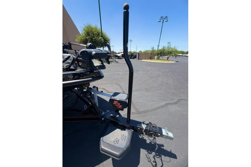 Slide: The Image of 2018 Bass Cat Caracal boat trailer hitch in a parking lot under clear blue sky. - 12