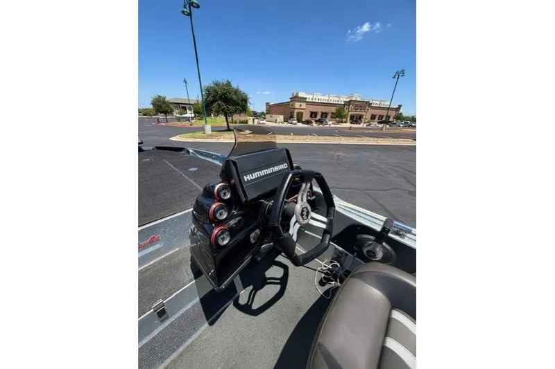 Slide: The Image of 2018 Bass Cat Caracal boat dashboard with steering wheel and Humminbird electronics. - 8