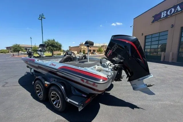 Slide: The Image of 2018 Bass Cat Caracal boat with trailer, parked outdoors on a sunny day. - 3