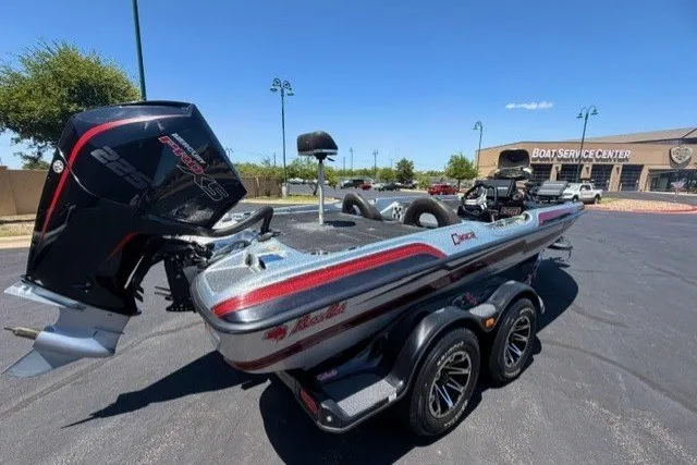 Slide: The Image of 2018 Bass Cat Caracal boat with powerful engine, parked near a boat service center. - 4
