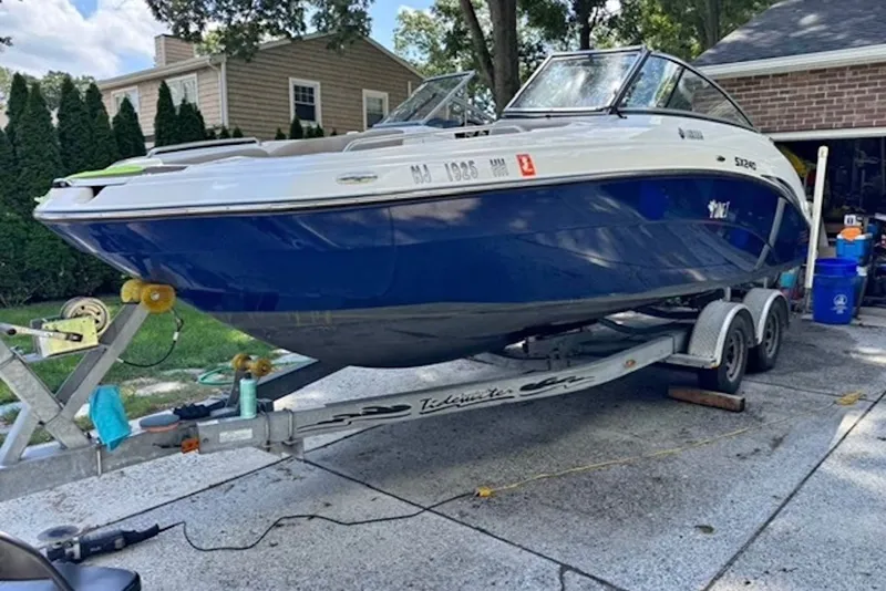 Slide: The Image of 2011 Yamaha Boats SX240 HO on trailer, parked in driveway near house. - 6