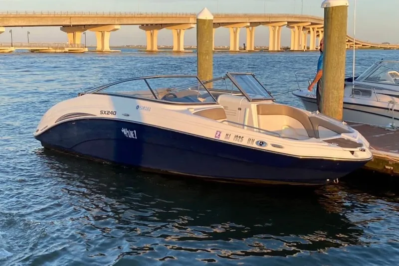 The Image of 2011 Yamaha Boats SX240 HO docked near a bridge on calm waters. - 0