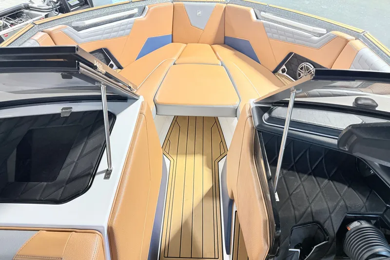 Slide: The Image of Interior of 2022 Nautique Super Air Nautique S23 boat with tan seating and sleek design. - 36