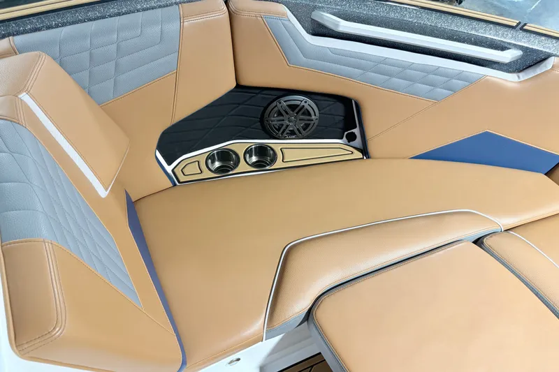 Slide: The Image of Luxurious interior of 2022 Nautique Super Air Nautique S23 boat with tan and gray seating. - 26