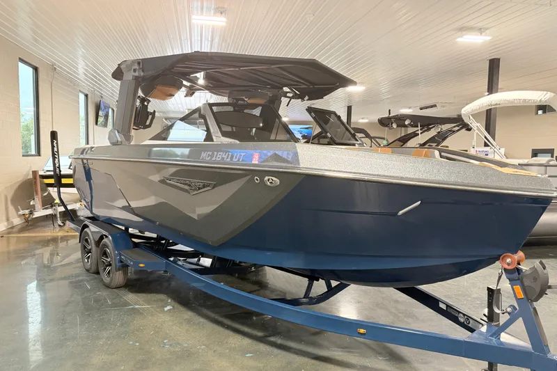 Slide: The Image of 2022 Nautique Super Air Nautique S23 boat on trailer in showroom. - 9