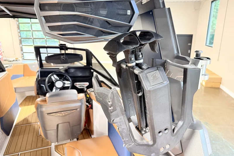 Slide: The Image of 2022 Nautique Super Air Nautique S23 interior with steering wheel and speaker system. - 32
