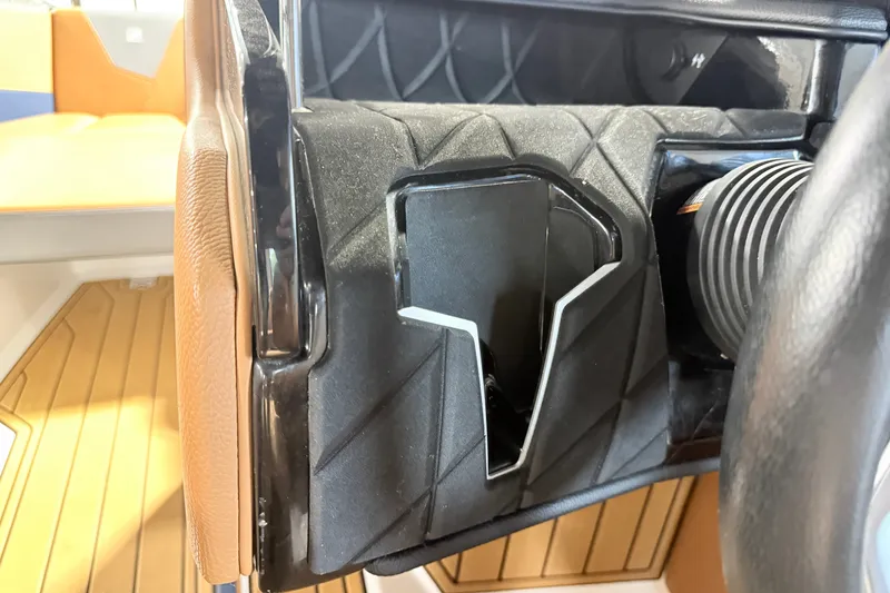 Slide: The Image of Interior detail of 2022 Nautique Super Air Nautique S23 boat, featuring a sleek black compartment. - 35