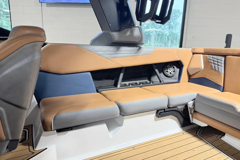 Slide: The Image of Interior of 2022 Nautique Super Air Nautique S23 with tan and gray seating. - 16