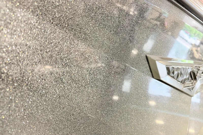 Slide: The Image of Close-up of 2022 Nautique Super Air Nautique S23 metallic finish with emblem. - 24