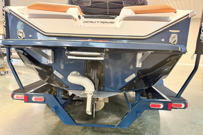 Slide: The Image of 2022 Nautique Super Air Nautique S23 boat rear view in showroom. - 11
