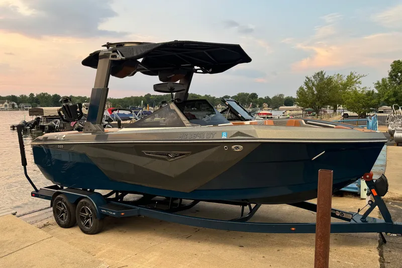 The Image of 2022 Nautique Super Air Nautique S23 boat on trailer by lakeside at sunset. - 0