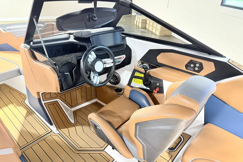 Slide: The Image of 2022 Nautique Super Air Nautique S23 interior with modern helm and luxurious seating. - 17