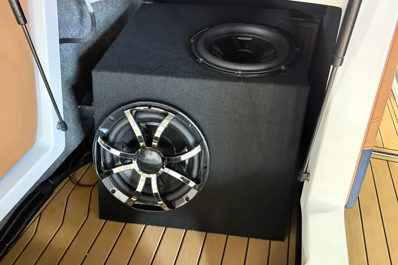 Slide: The Image of Subwoofer installed in a 2022 Nautique Super Air Nautique S23 boat interior. - 19
