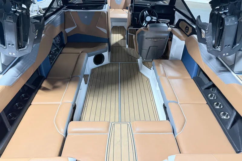 Slide: The Image of 2022 Nautique Super Air Nautique S23 interior with tan seating and sleek design. - 14