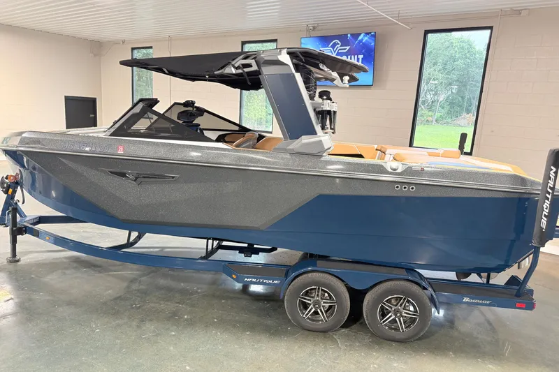 Slide: The Image of 2022 Nautique Super Air Nautique S23 boat on trailer in showroom. - 6
