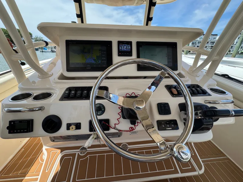Slide: The Image of The image shows the helm of a 2016 Grady-White Canyon 336 boat with modern instruments. - 10