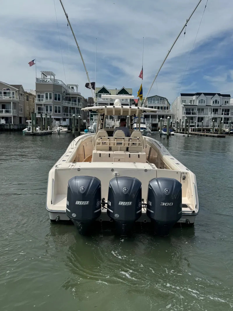 Slide: The Image of A 2016 Grady-White Canyon 336 boat with three Yamaha 300 engines, on the water in a harbor. - 7