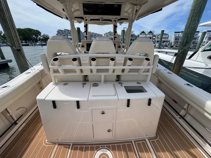 Slide: The Image of The image shows the cockpit of a 2016 Grady-White Canyon 336 boat with rod holders and storage. - 15