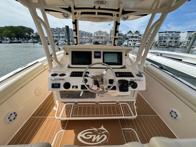 Slide: The Image of The image shows the cockpit of a 2016 Grady-White Canyon 336. It features modern instruments and a sleek design. - 13