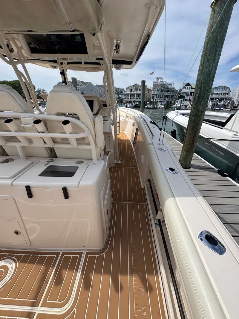 Slide: The Image of The image shows the deck of a 2016 Grady-White Canyon 336 docked at a marina. - 17