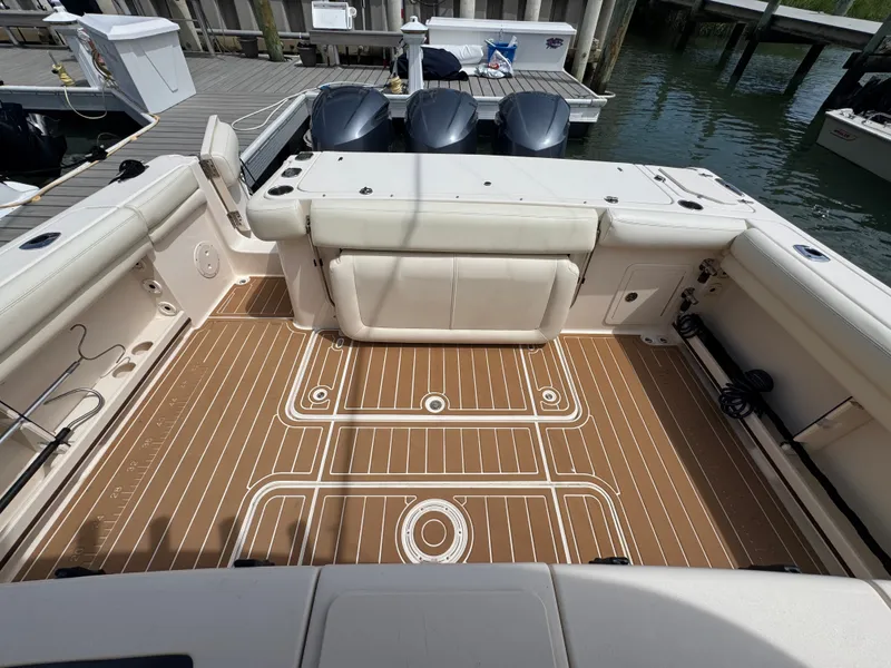 Slide: The Image of The image shows the spacious cockpit of a Grady-White Canyon 336 boat with three outboard engines. - 20