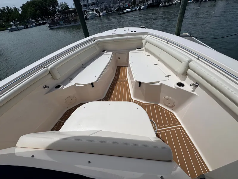 Slide: The Image of The image shows the bow area of a Grady-White Canyon 336 boat with beige seating. - 22