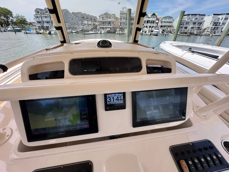 Slide: The Image of The image shows the cockpit of a 2016 Grady-White Canyon 336 with modern navigation systems. - 11