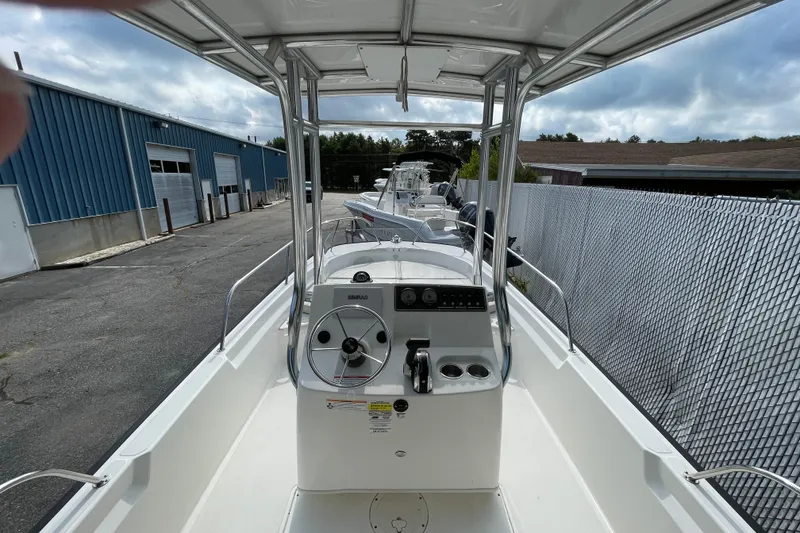 Slide: The Image of 2023 Boston Whaler 190 Montauk boat interior with steering console and canopy. - 3