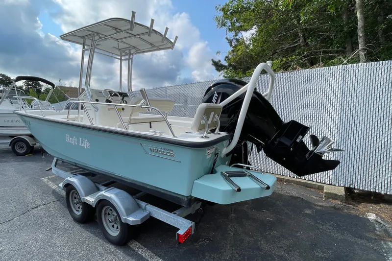 Slide: The Image of 2023 Boston Whaler 190 Montauk boat on trailer, parked outdoors. - 10