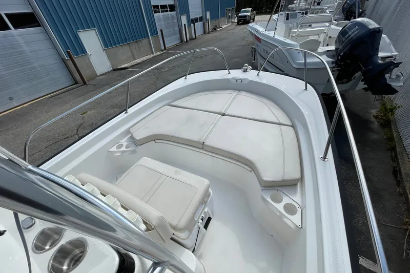 Slide: The Image of 2023 Boston Whaler 190 Montauk boat interior with cushioned seating and cup holders. - 8