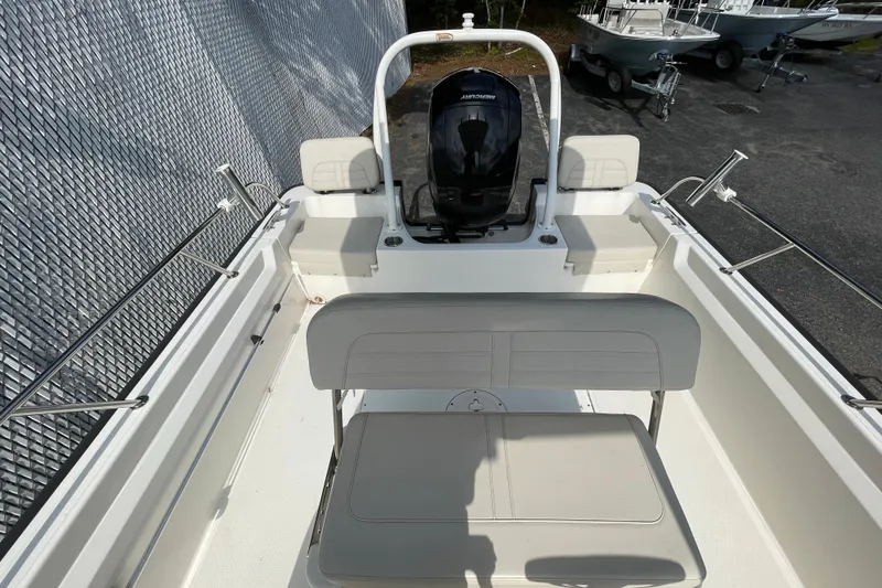 Slide: The Image of 2023 Boston Whaler 190 Montauk boat interior with seating and Mercury engine. - 6