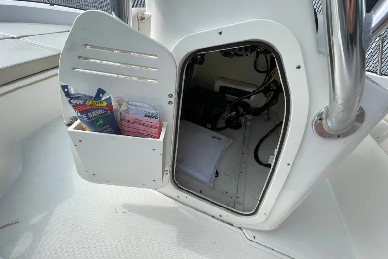 Slide: The Image of Storage compartment on a 2023 Boston Whaler 190 Montauk boat, showing equipment and supplies. - 5