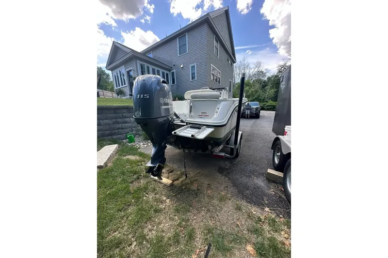 Slide: The Image of 2021 Edgewater 170CC boat with Yamaha 115 engine parked in driveway. - 2