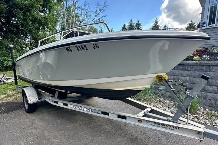 The Image of 2021 Edgewater 170CC boat on trailer, parked outdoors, showcasing sleek design and sturdy build. - 0