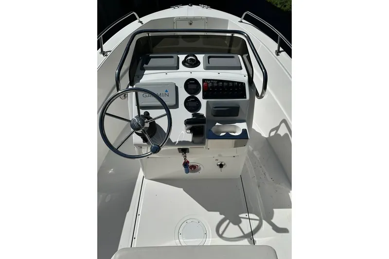 Slide: The Image of 2021 Edgewater 170CC boat console with steering wheel and Garmin navigation system. - 6
