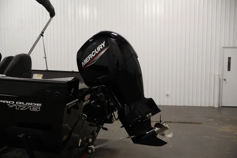 Slide: The Image of 2025 Tracker Pro Guide V-175 WT boat with Mercury outboard motor in a garage. - 45