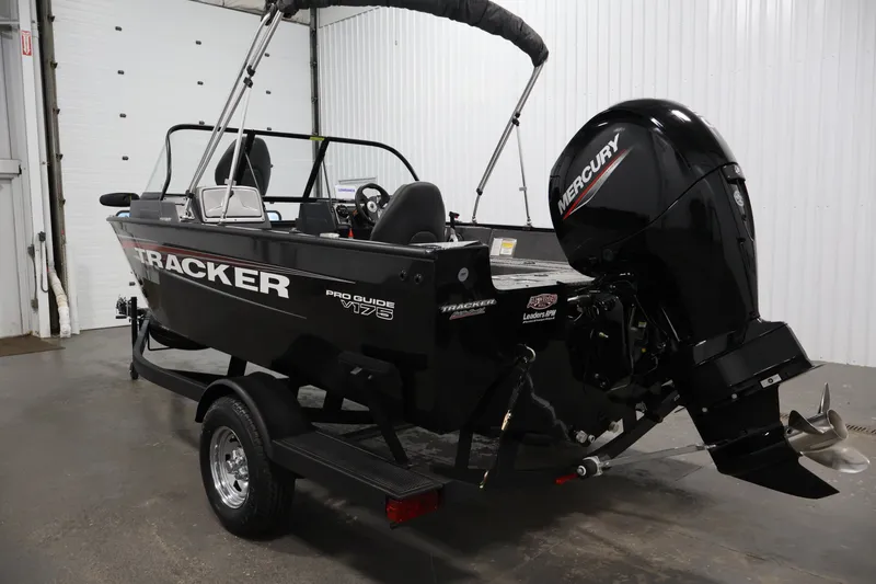 Slide: The Image of 2025 Tracker Pro Guide V-175 WT boat with Mercury engine in a garage setting. - 7
