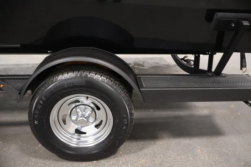 Slide: The Image of Trailer wheel of 2025 Tracker Pro Guide V-175 WT boat, featuring durable tire and fender. - 52