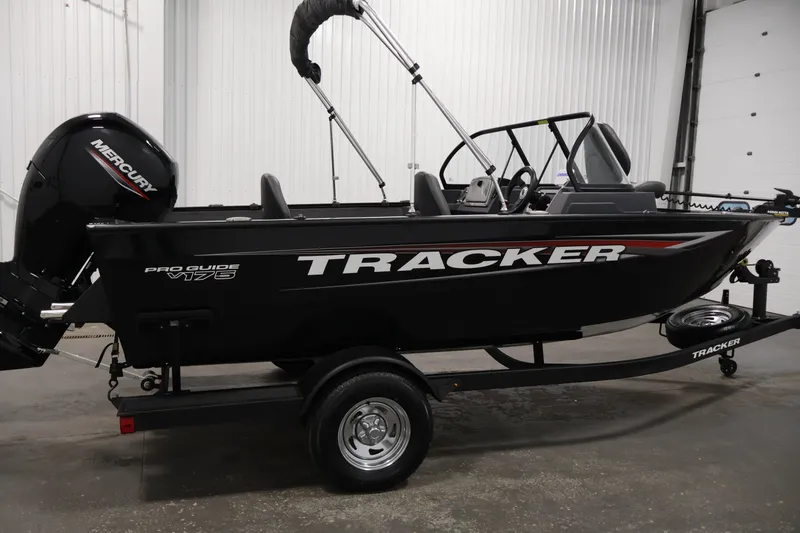 Slide: The Image of 2025 Tracker Pro Guide V-175 WT boat with Mercury engine in a showroom. - 4