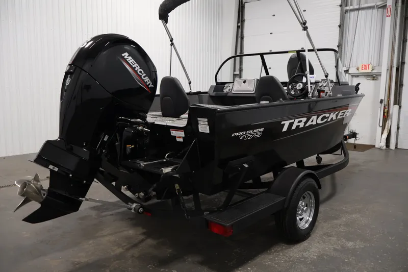 Slide: The Image of 2025 Tracker Pro Guide V-175 WT boat with Mercury engine in a garage setting. - 5