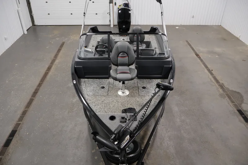 Slide: The Image of 2025 Tracker Pro Guide V-175 WT fishing boat in a garage setting. - 9